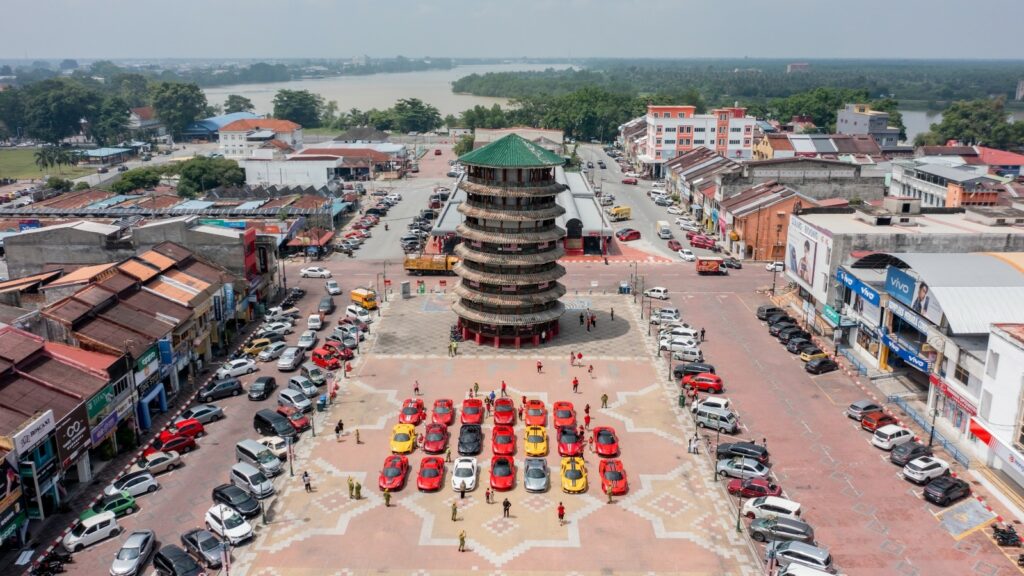 Members of the Ferrari Owners’ Club Malaysia members and their vehicles parked at the iconic Menara Condong located in the heart of Teluk Intan town.