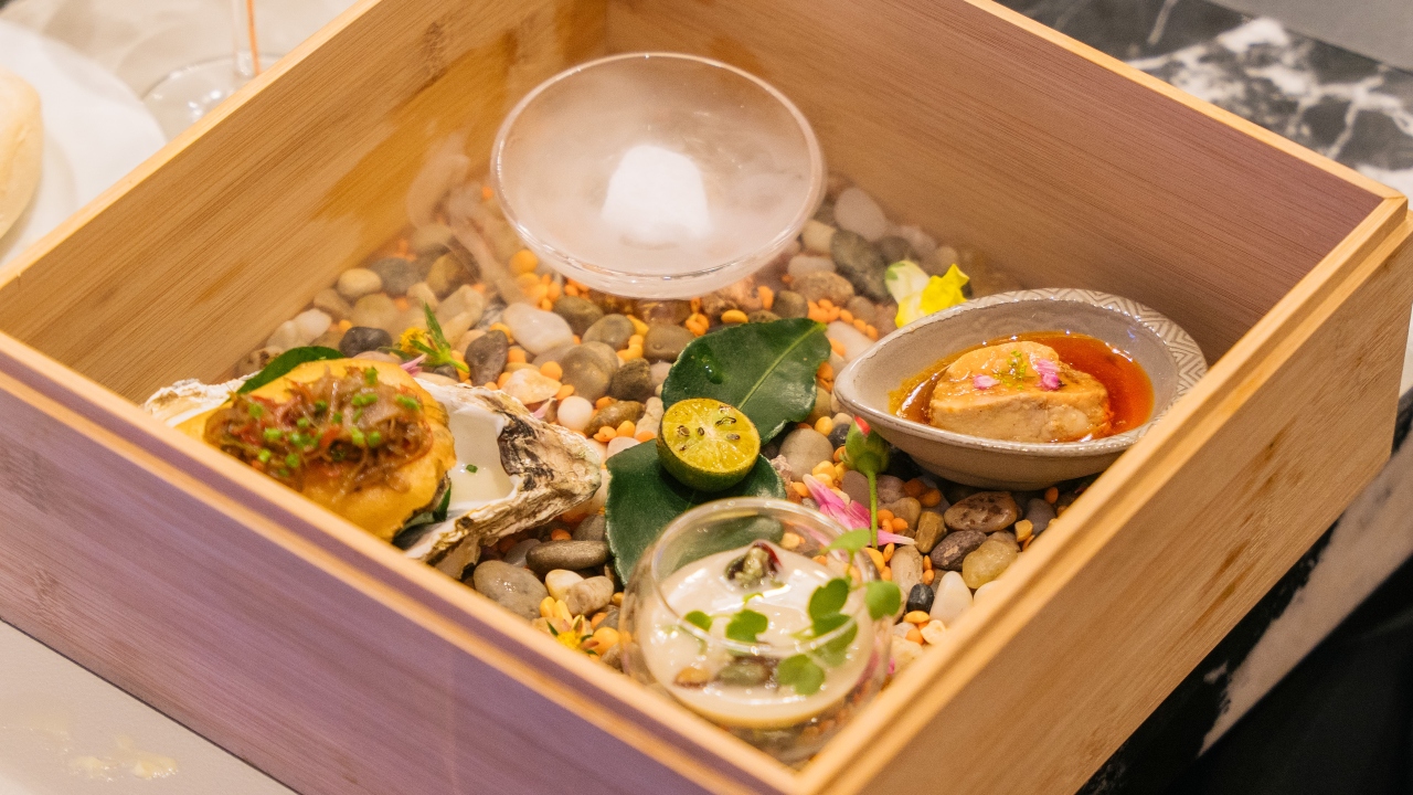 A box set of percebes in Tom Kha emulsion, Japanese Ankimo in a ponzu reduction, and Taishan oysters beignet.