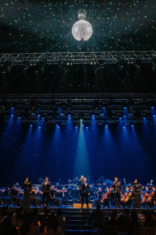 The ensemble on stage beneath the revolving disco ball.