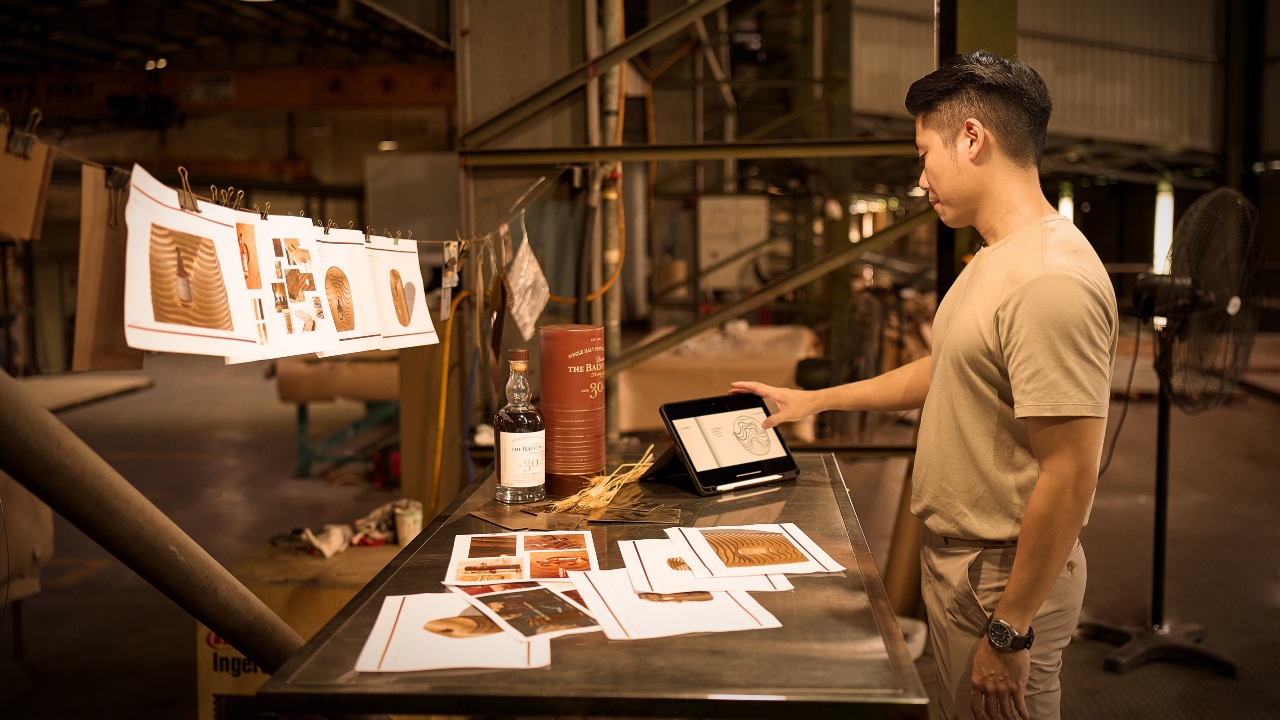 Designer Edward Tan pouring over his work.